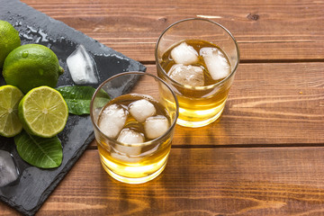 glass of whiskey on wooden background