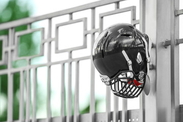 Rugby helmet on metal fence
