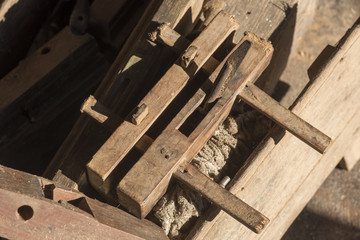 Desk of a carpenter tools. Studio shot on a wooden background.