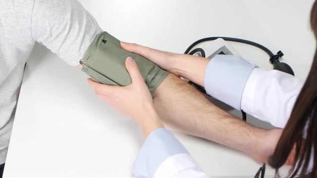 Closeup of sphygmomanometer being used of woman doctor