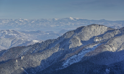 Winter landscape with Carpathians mountains on clear sunny day, Romania.