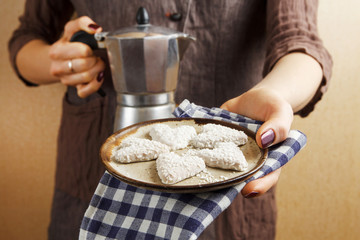 Hands holding valentine biscuit and coffee. Valentine's Day Concept
