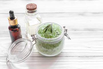 organic cosmetics with extracts of herbs rosemary on wooden background