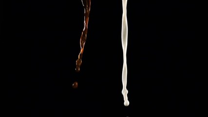 Pouring coffee and milk and making splashes on black background - Powered by Adobe