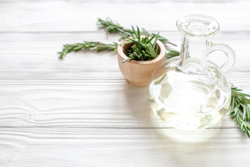 organic cosmetics with extracts of herbs rosemary on wooden background