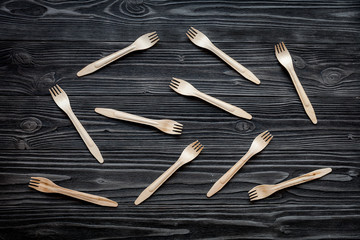 wooden kitchen utensils on dark background top view pattern
