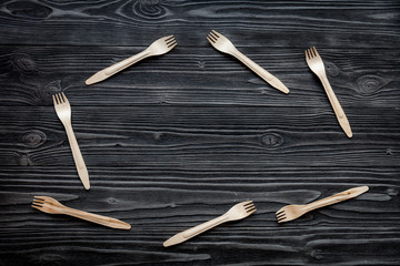 Fototapeta na wymiar wooden kitchen utensils on dark background top view mock up
