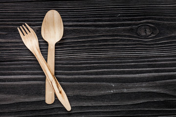wooden kitchen utensils on dark background top view mock up
