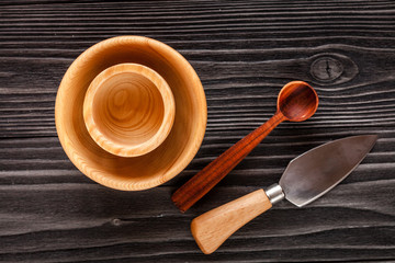 wooden kitchen utensils on dark background top view