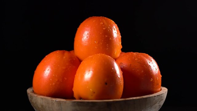 Red ripe persimmons rotating