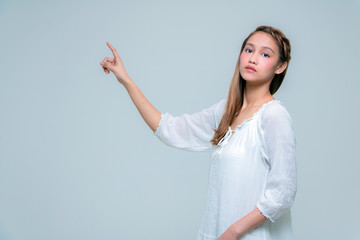 young latina girl pointing in the air