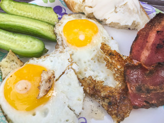 Plate with fried eggs and bacon