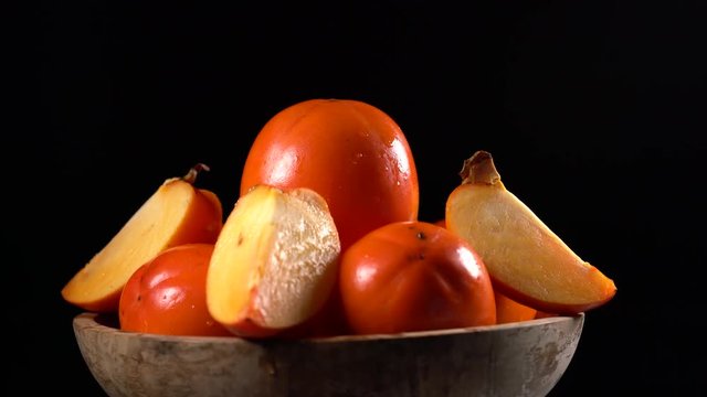 Red ripe persimmons rotating