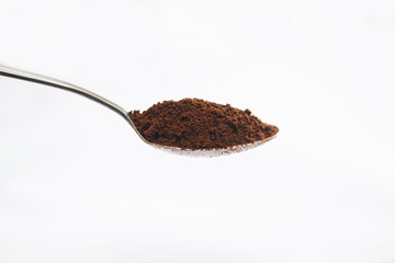 Coffee in a spoon isolated on white
