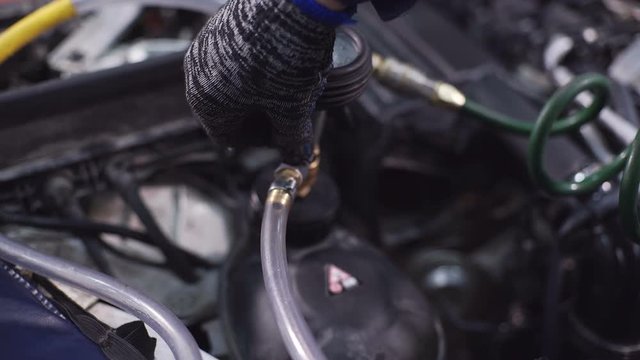 Demonstrates how to change oil in gear box shift car at the station.