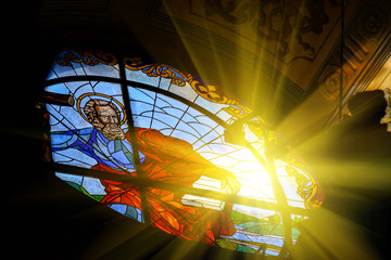 The Bernardine church and monastery (church of St. Andrew) in Lviv, Ukraine. Church and fortification was built in 1600-1630. Beautiful stained glass window with sunlight. Religion and art concept.