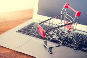 Tablet and shopping cart on wood table, Online shopping concept
