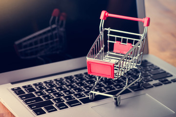Tablet and shopping cart on wood table, Online shopping concept