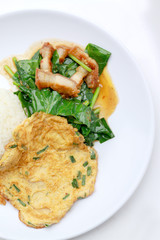 Stir fried kale with crispy pork and Thai Omelette with rice in white dish iIsolated on white background, Thai Food