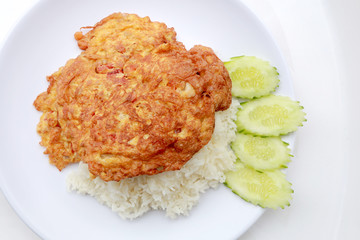 Omelet served with jasmine rice in white dish isolated on white background