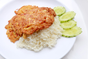 Omelet served with jasmine rice in white dish isolated on white background