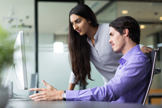 Two Focused Colleagues Finding Business Solution