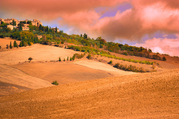 Fototapeta na wymiar Tuscany Italy landscape at sunset with rolling hills along countryside farms.