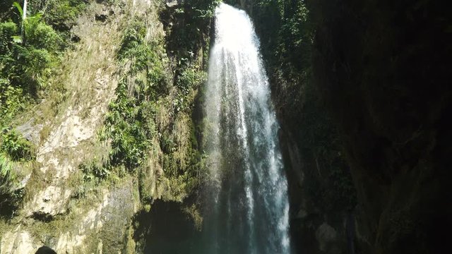 Beautiful waterfall in green forest in jungle. Waterfall in the mountains. Tropical rain forest with waterfall. Philippines, Cebu. 4K video. Travel concept.