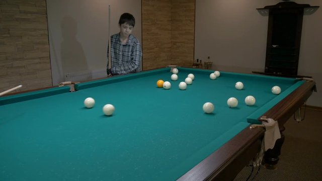 Russian billiards. Father teaches son to play pool