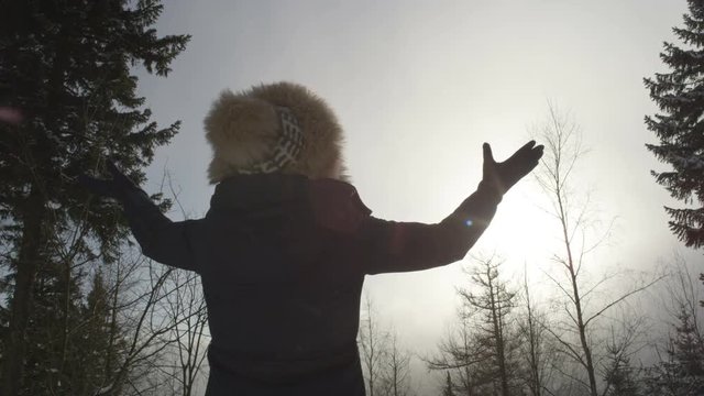 Young woman enjoying view in a winter mountain forest. Shot On Red Epic.