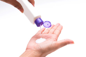 woman pouring body lotion on hand