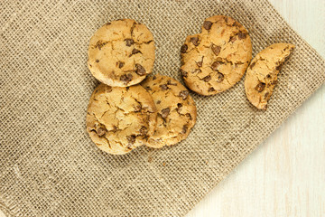 Chocolate chips cookie on burlap texture, with copyspace