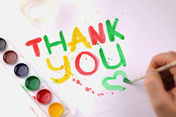 inscription on white sheet of paper with watercolors "Thank you"