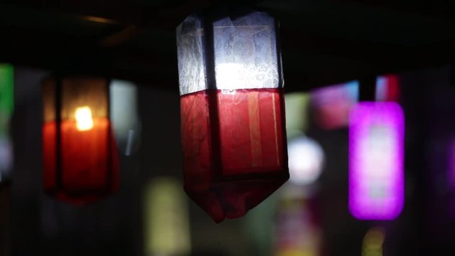 Traditional Asian paper lantern at night on a city street