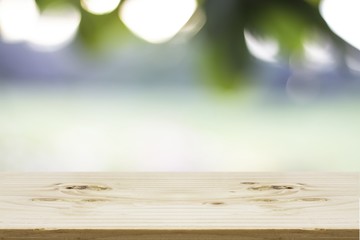 Fototapeta premium Wood table top on blur of nature background, used for display your products