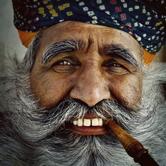 India Man Smoking a Pipe Concept