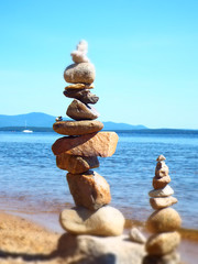 closeup of rock cairns along waters edge