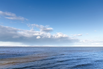 Fototapeta premium bright Sunny day / cloudy sky over water