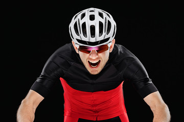 Sport. Cyclist in training clothes on black background.