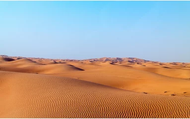  Arabian desert dune background on blue sky © ghoststone