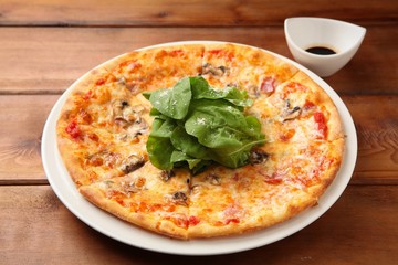 arugula  pizza on table