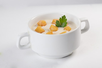 cream soup with croutons isolated on white background parsley leaf