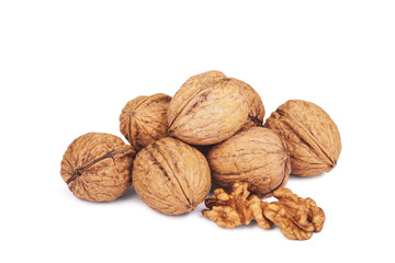 Walnut kernels and whole walnuts on white background