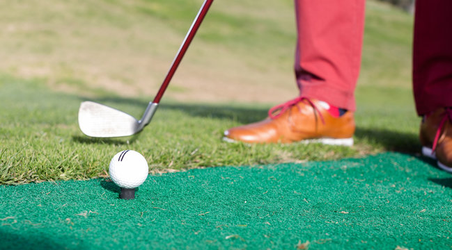 iron to ball and takes aim