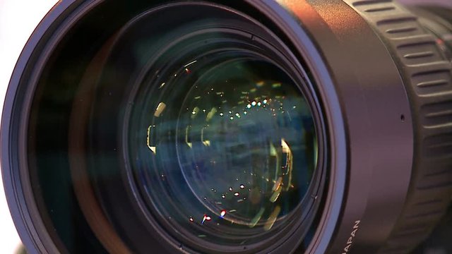 The lens of the camera.Zoom camera. Closeup shot of professional video camera with a zoom lens.