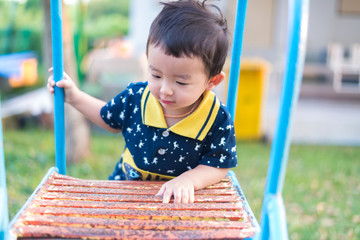 Asian kid goes up the stairs in the park. concept of growing up.