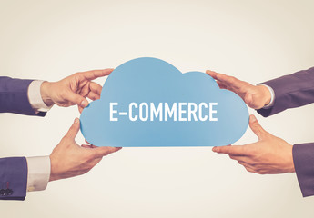 Two men holding cloud with E-Commerce text