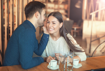 Beautiful loving couple flirting in a cafe. Love and romance. Da