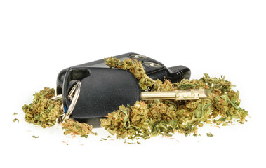 Driving high, marijuana and car key isolated on white