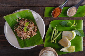 spicy minced pork salad on fresh banana leaf